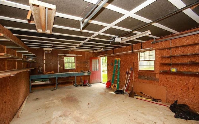 290 Timber Ridge Trl, Carrollton, GA 30117 - garage with a workshop area, a garage door opener, and wood walls