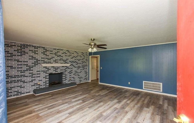 290 Timber Ridge Trl, Carrollton, GA 30117 - unfurnished living room with ceiling fan, wood finished floors, a fireplace, and a textured ceiling