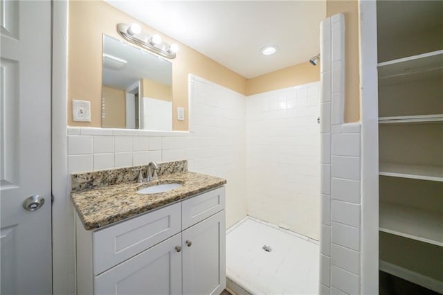 2725 Rainbow Forest Dr, Decatur, GA 30034 - bathroom featuring vanity, a tile shower, tile walls, and backsplash