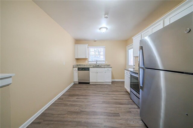 2725 Rainbow Forest Dr, Decatur, GA 30034 - kitchen featuring appliances with stainless steel finishes, light hardwood / wood-style floors, sink, and white cabinets