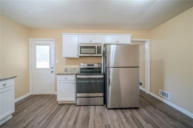 2725 Rainbow Forest Dr, Decatur, GA 30034 - kitchen featuring light stone counters, stainless steel appliances, dark hardwood / wood-style flooring, and white cabinets