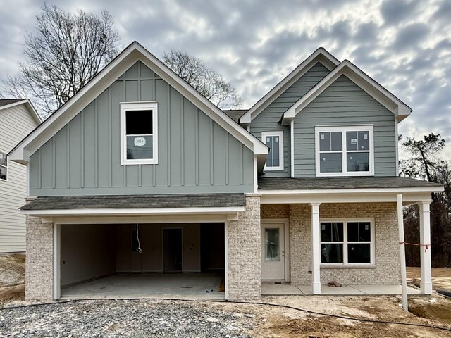 view of front of home featuring covered porch and a garage