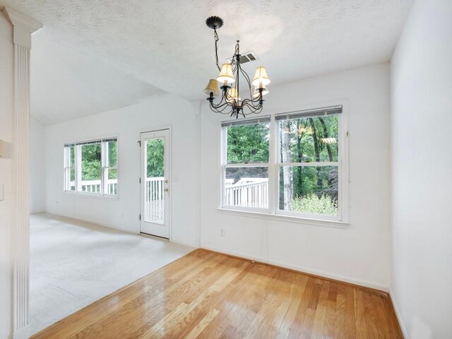 2910 Waverly Place Dr, Dacula, GA 30019 - unfurnished room with a chandelier, light wood-type flooring, baseboards, and a textured ceiling