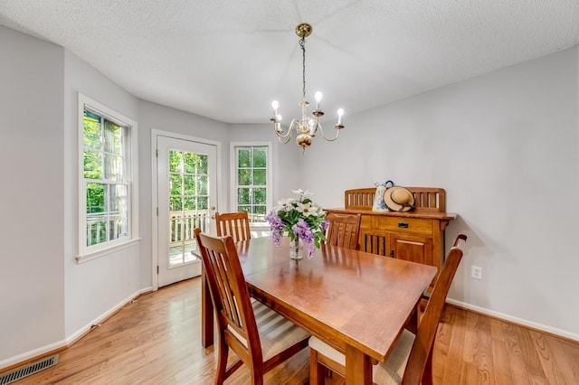 215 Twin Creek Shrs, Athens, GA 30605 - dining room with a chandelier, light wood-type flooring, and a textured ceiling