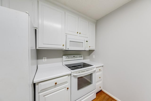 215 Twin Creek Shrs, Athens, GA 30605 - kitchen featuring white appliances, white cabinets, light countertops, and light wood-style flooring