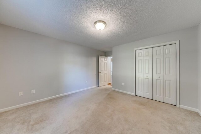 215 Twin Creek Shrs, Athens, GA 30605 - unfurnished bedroom with carpet floors, a textured ceiling, and a closet