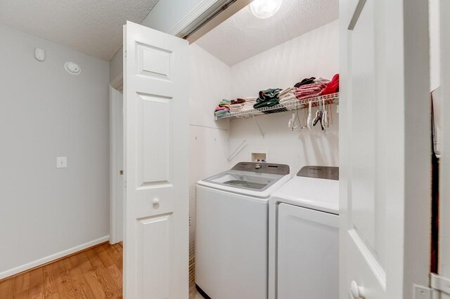 215 Twin Creek Shrs, Athens, GA 30605 - laundry room featuring separate washer and dryer, light wood-style floors, and a textured ceiling