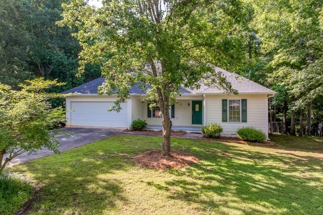215 Twin Creek Shrs, Athens, GA 30605 - ranch-style home featuring asphalt driveway, an attached garage, a front yard, and a porch