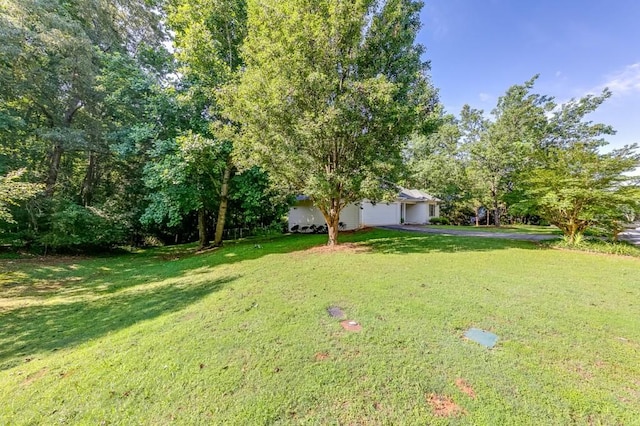 215 Twin Creek Shrs, Athens, GA 30605 - view of grassy yard featuring an attached garage and driveway