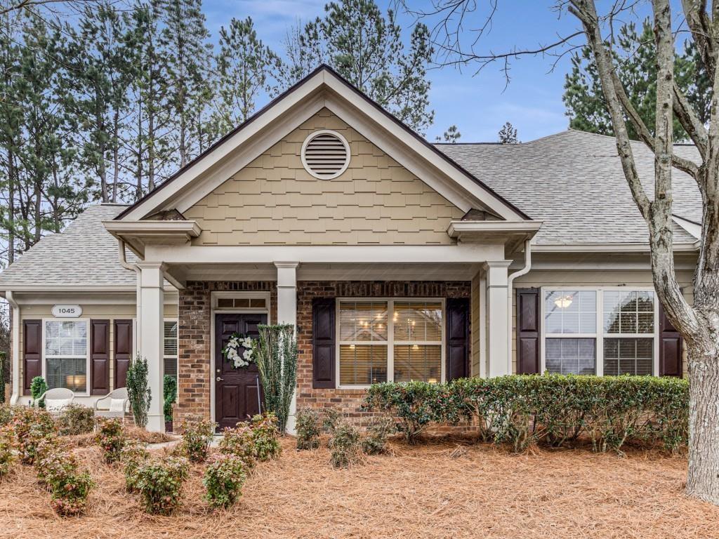 1045 Brook Knoll Ln Unit 401, Cumming, GA 30041 - view of front of home with a shingled roof and brick siding