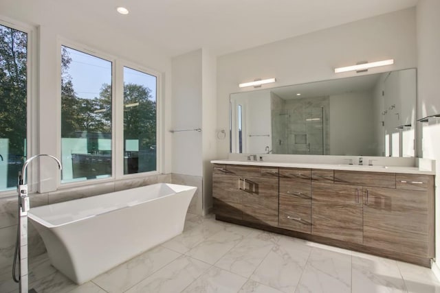 2194 Bristol Cv Unit 13, Chamblee, GA 30341 - full bath featuring double vanity, marble look tiles, a soaking tub, a shower stall, and recessed lighting