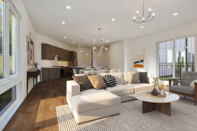 living room with light hardwood / wood-style floors and an inviting chandelier