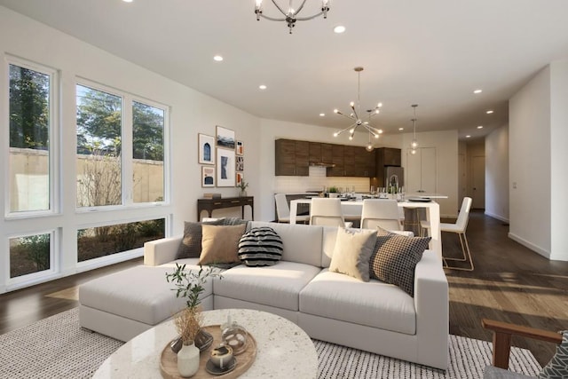 living room featuring dark hardwood / wood-style floors and an inviting chandelier