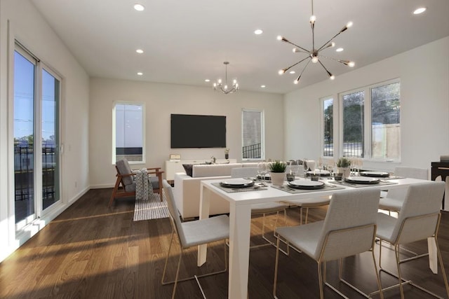 unfurnished living room with an inviting chandelier, dark wood-type flooring, and sink