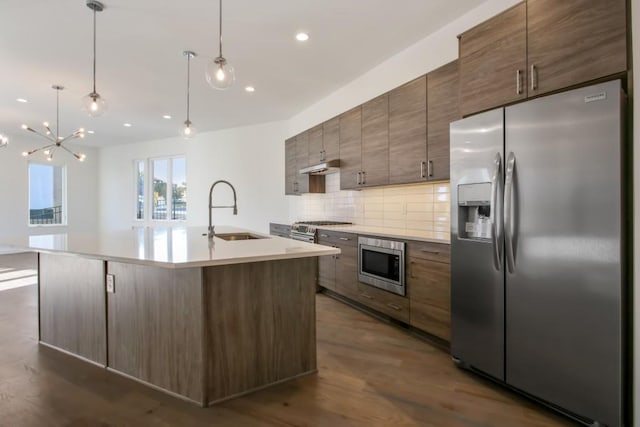2194 Bristol Cv Unit 13, Chamblee, GA 30341 - kitchen with stainless steel appliances, tasteful backsplash, a center island with sink, dark wood finished floors, and recessed lighting