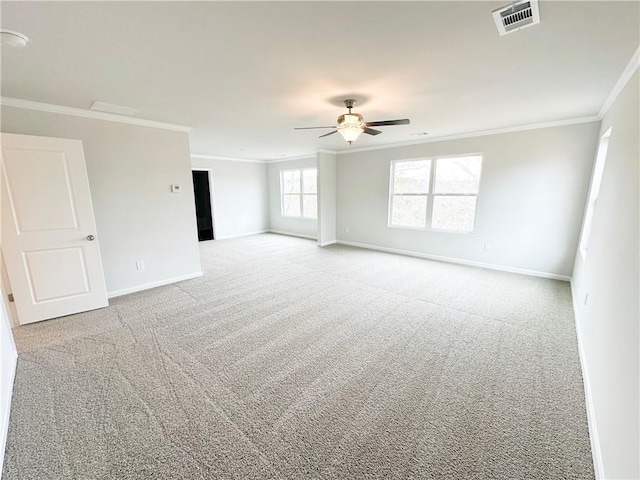 unfurnished room with visible vents, crown molding, baseboards, and carpet floors