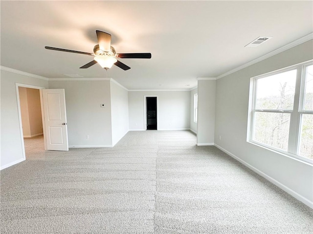 unfurnished room featuring crown molding, baseboards, and visible vents