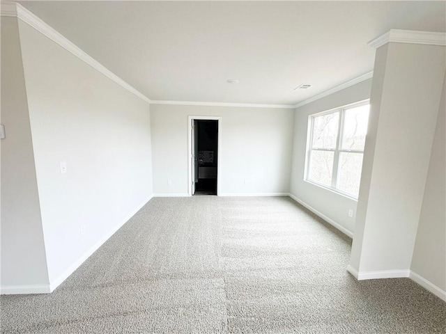 unfurnished room with visible vents, crown molding, baseboards, and carpet floors