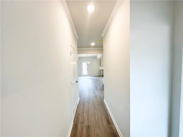 hallway with recessed lighting, baseboards, wood finished floors, and crown molding