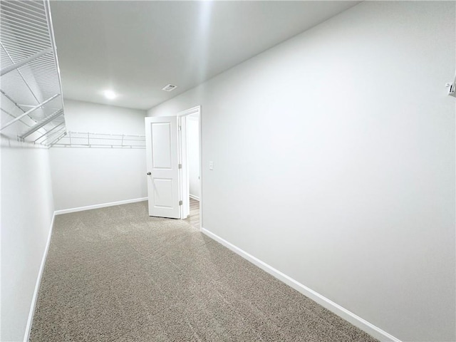 walk in closet featuring visible vents and carpet flooring