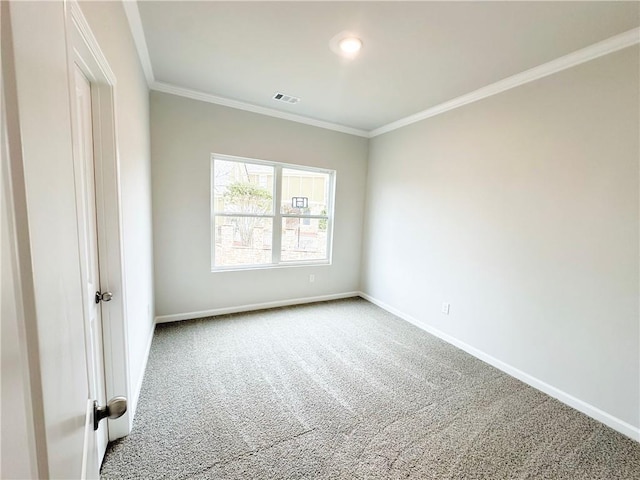 carpeted spare room featuring visible vents, baseboards, and ornamental molding