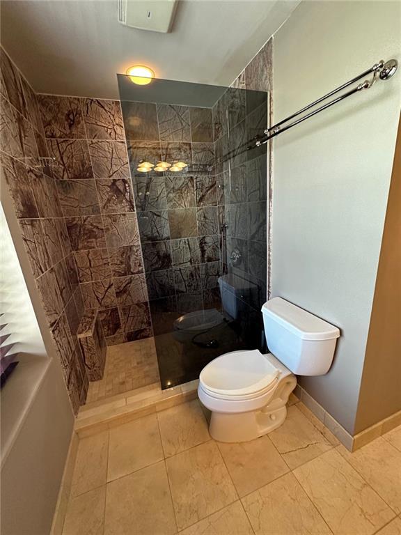 bathroom with tiled shower