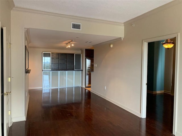 unfurnished living room with ornamental molding and dark hardwood / wood-style flooring