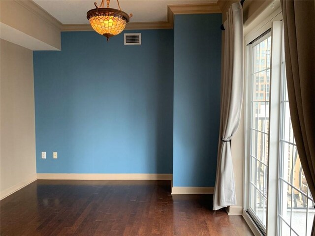 unfurnished living room featuring dark hardwood / wood-style floors and crown molding