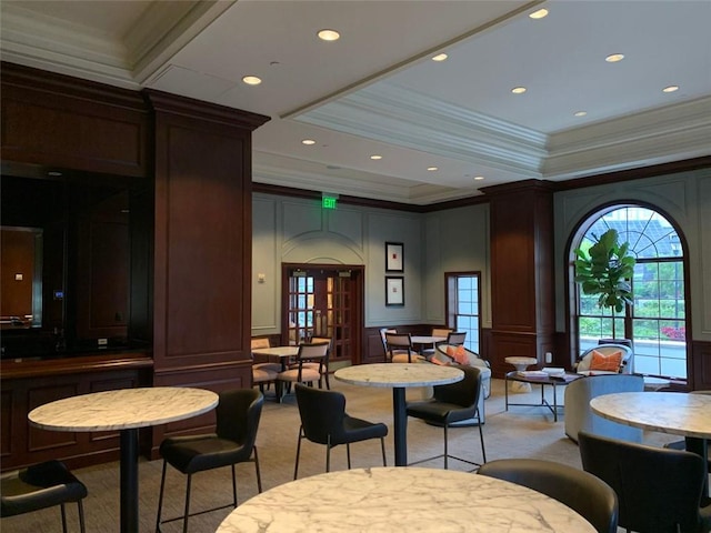 carpeted dining area with ornamental molding