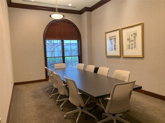 carpeted dining area with ornamental molding