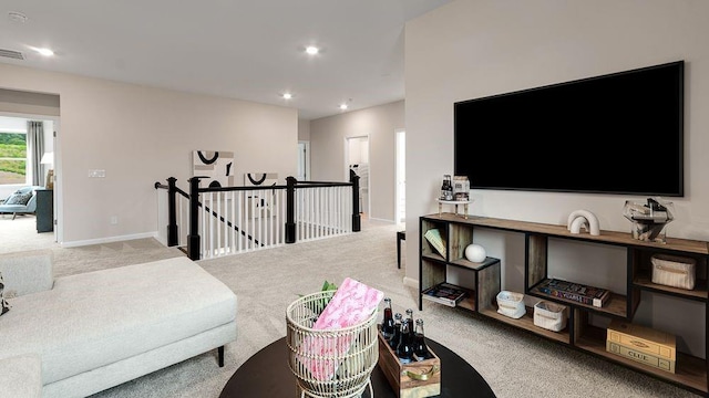 sitting room with baseboards, carpet flooring, an upstairs landing, and recessed lighting