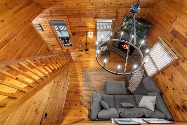 unfurnished living room featuring wood-type flooring and wood walls