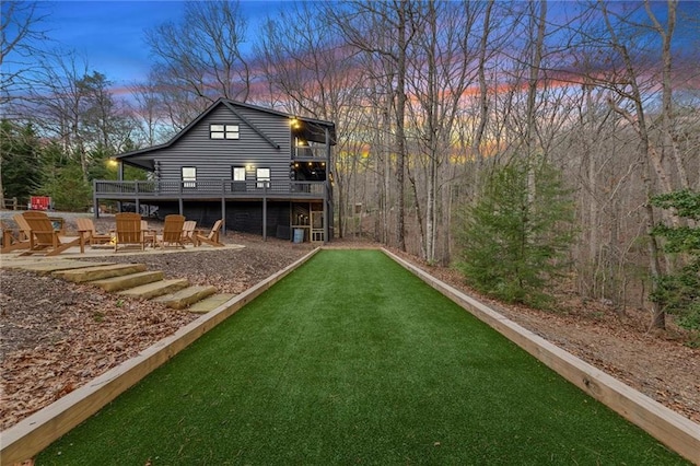 rear view of property featuring an outdoor fire pit and a patio