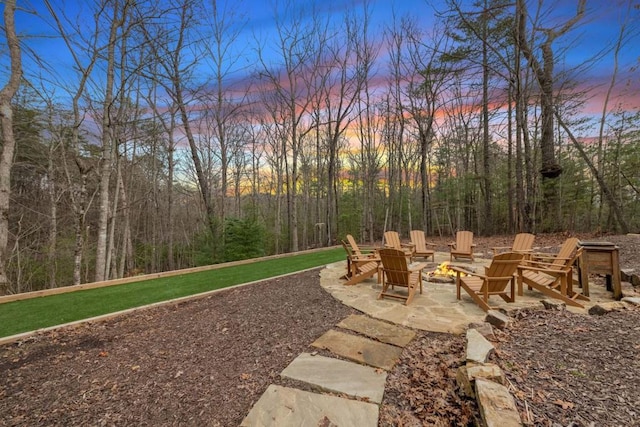 yard at dusk with a fire pit and a patio