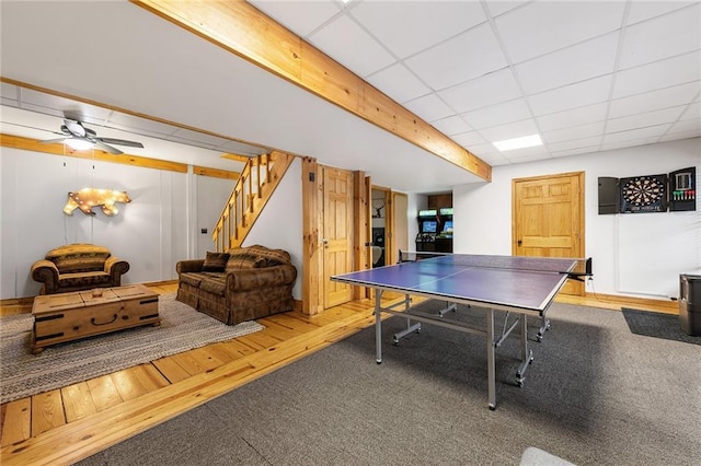 playroom featuring a drop ceiling, ceiling fan, and wood finished floors