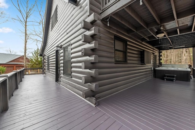 wooden deck featuring a hot tub