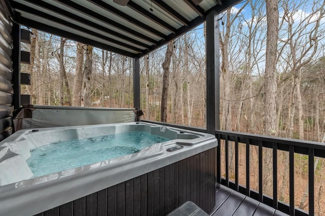 wooden deck with a hot tub