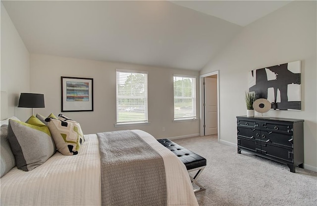 bedroom featuring baseboards, carpet flooring, and lofted ceiling