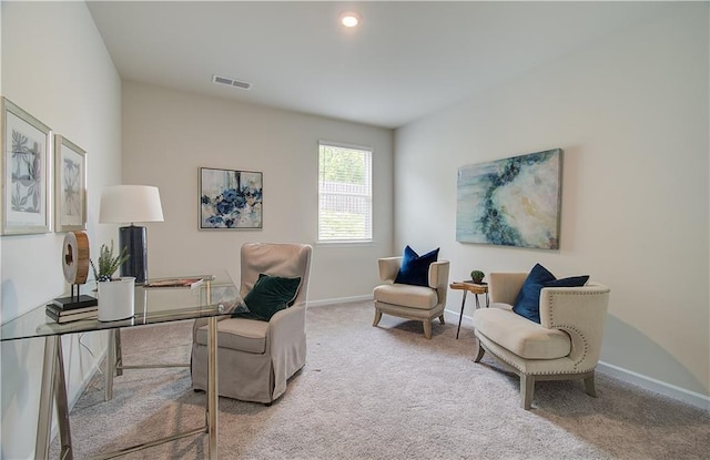 carpeted office space featuring baseboards and visible vents