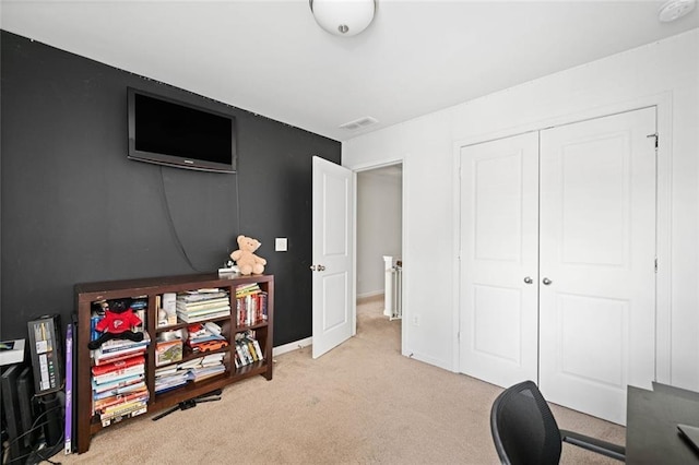 carpeted office space with baseboards and visible vents