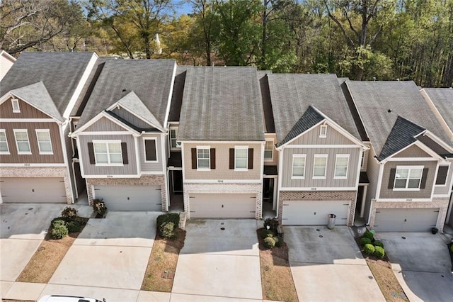 view of property featuring an attached garage, board and batten siding, and concrete driveway