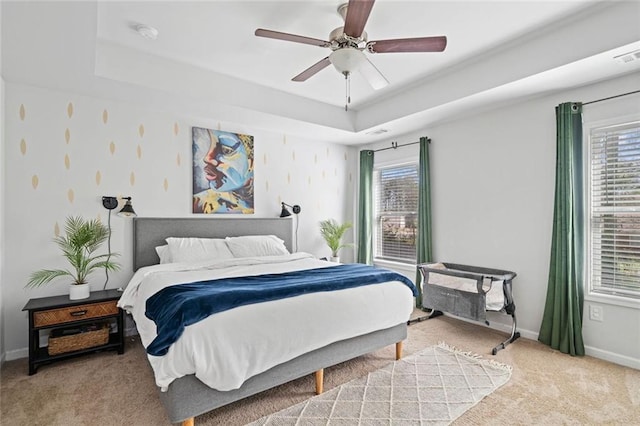bedroom featuring carpet floors, baseboards, and multiple windows