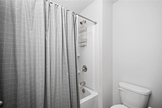 full bath with shower / bath combo with shower curtain and toilet