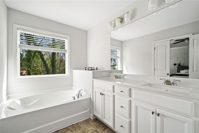 full bath with double vanity, a sink, ensuite bathroom, and a bath
