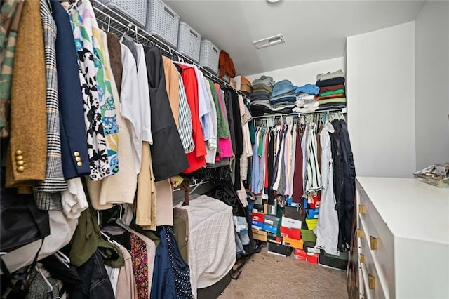 walk in closet featuring visible vents and carpet flooring