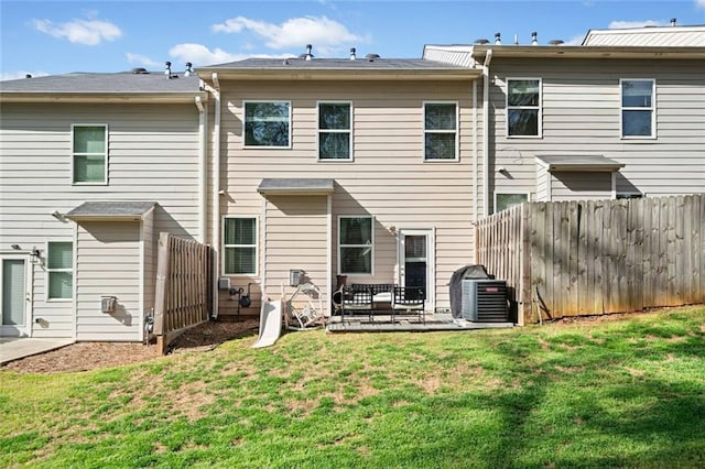 rear view of house with a yard, central AC, fence, and a patio area