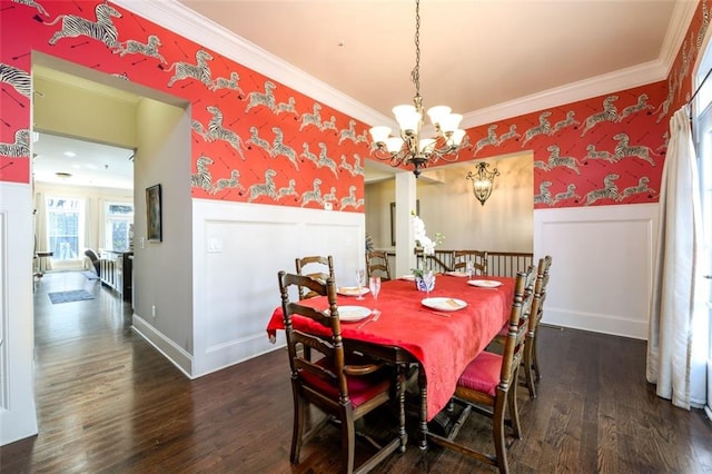 dining space featuring wallpapered walls, dark wood-style floors, ornamental molding, and wainscoting