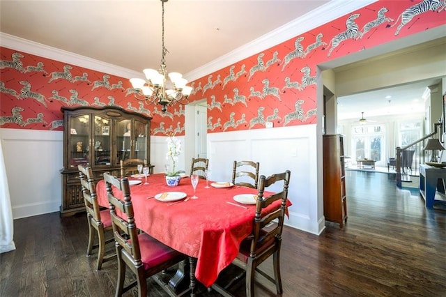 dining space with ornamental molding, a wainscoted wall, dark wood finished floors, and wallpapered walls