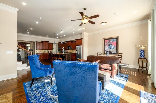 living area with dark wood-style floors, recessed lighting, ornamental molding, and stairs