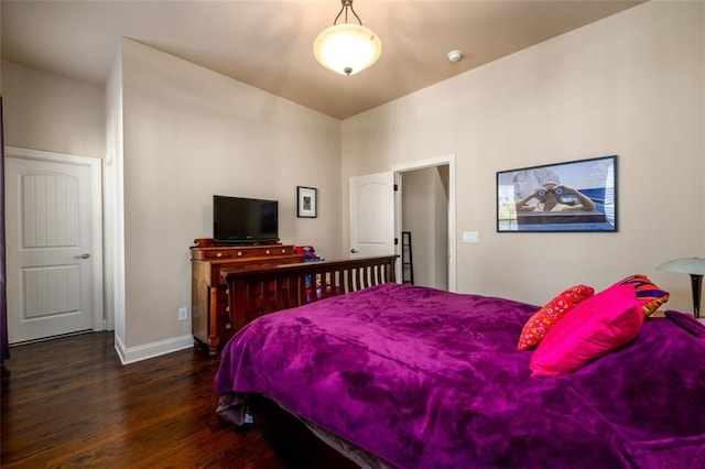 bedroom featuring dark wood-type flooring and baseboards